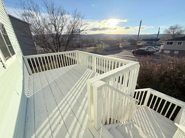 a view of a house with wooden deck