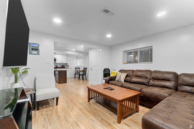 1489 North 400 West Bountiful, UT 84010 - Photo 26 of 47 Open-concept living area featuring wood-finish flooring, recessed lighting, and white walls