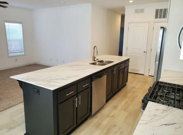 a kitchen with a sink a stove and a refrigerator