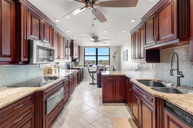 a view of a dining room with furniture a rug and wooden floor