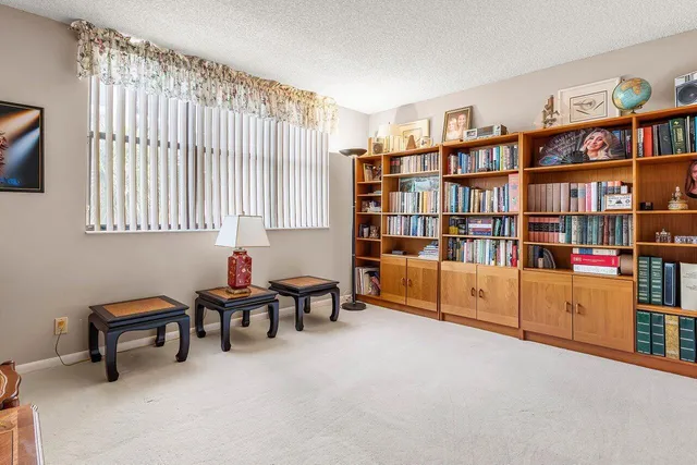 a bedroom with a large window and a chair