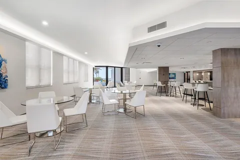a living room with furniture and view of kitchen