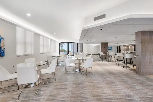 a living room with furniture and view of kitchen