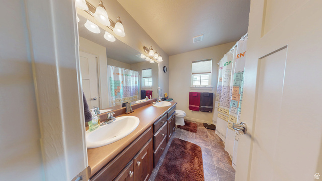 1674 Eastridge Road Price, UT 84501 - Photo 19 of 34 Bathroom featuring a dual vanity with integrated sinks, a lengthy countertop, and ample under-sink storage cabinetry