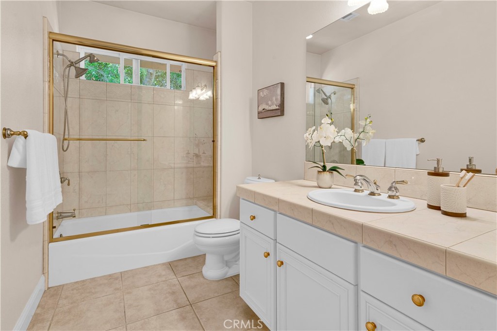 117 Frontier Way Templeton, CA 93465 - Photo 35 of 57 a bathroom with a double vanity sink toilet and shower