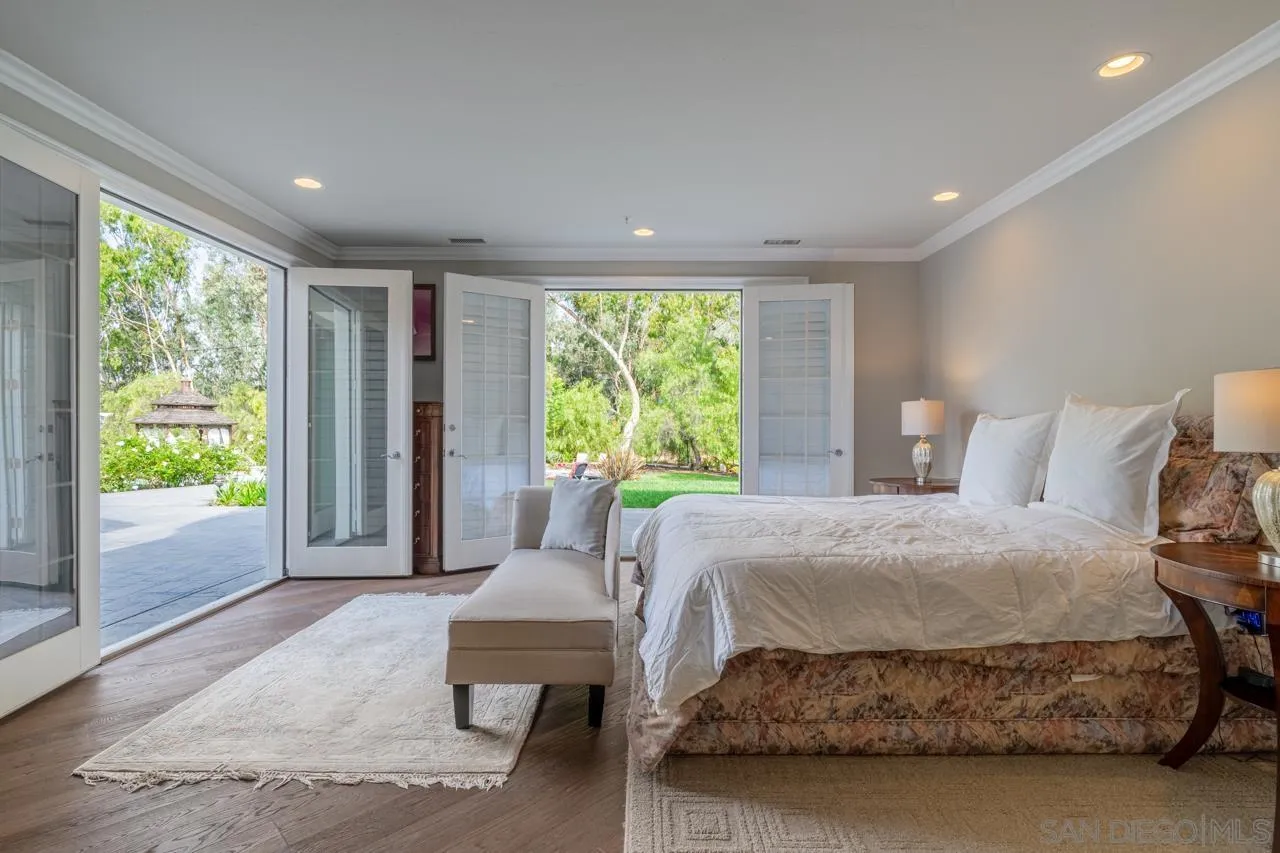 7012 Rancho La Cima Drive Rancho Santa Fe, CA 92067 - Photo 54 of 75 a bedroom with a bed and a large window