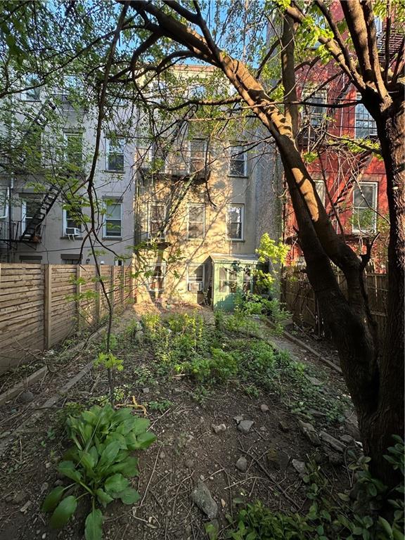 264 Berry Street Brooklyn, NY 11249 - Photo 12 of 21 a backyard of a building with lots of trees
