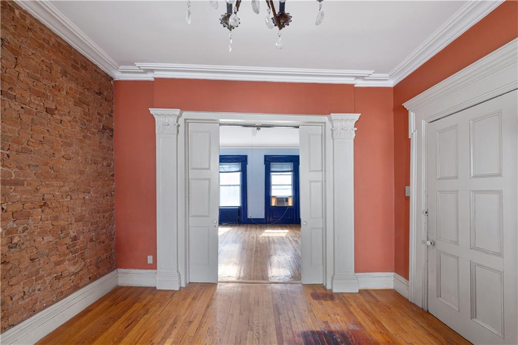 264 Berry Street Brooklyn, NY 11249 - Photo 7 of 21 a view of a hallway with wooden floor and staircase