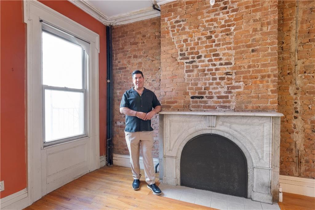 264 Berry Street Brooklyn, NY 11249 - Photo 9 of 21 a living room with a fireplace and a window