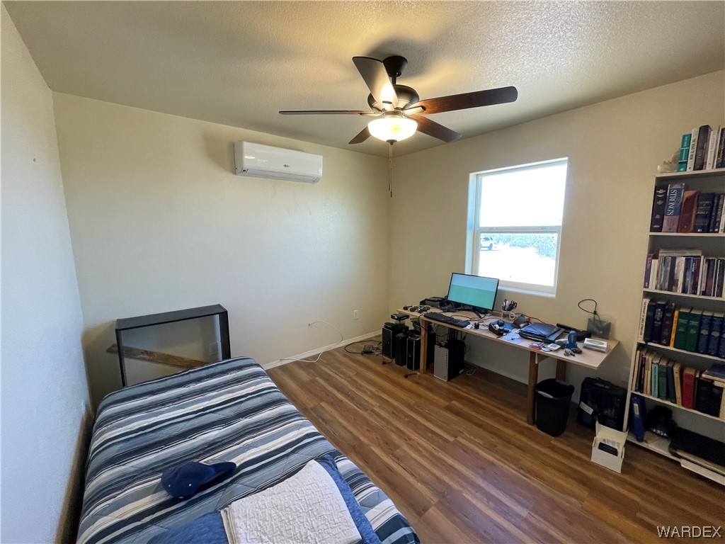 14438 Castle Butte Road Yucca, AZ 86438 - Photo 21 of 33 a bedroom with a bed and a chandelier