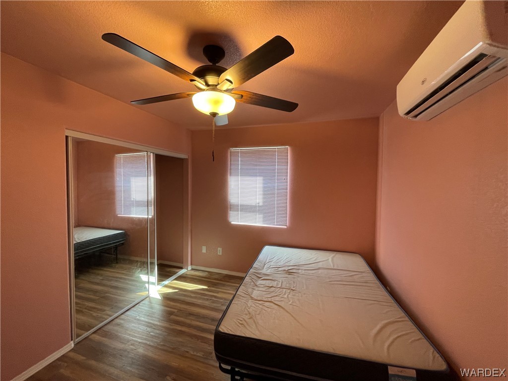 14438 Castle Butte Road Yucca, AZ 86438 - Photo 24 of 33 a bedroom with a bed and a chandelier