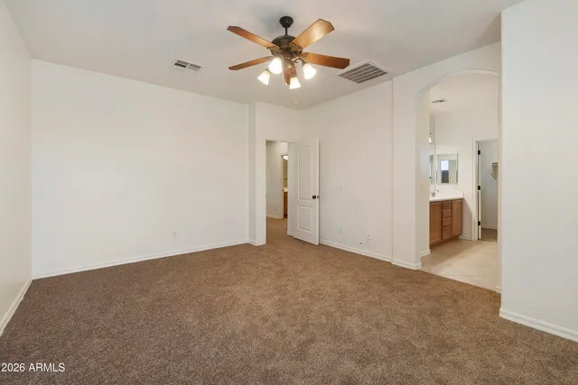 a view of an empty room with a ceiling fan