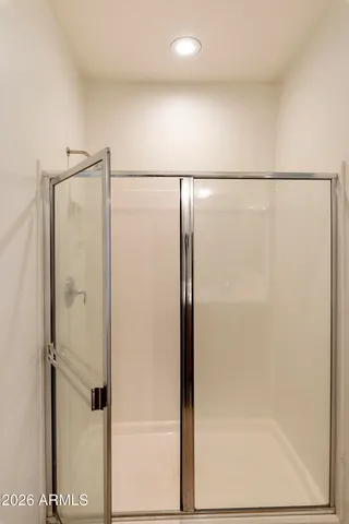 a bathroom with a glass shower door