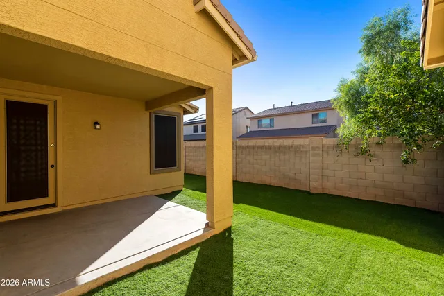 a view of an house with backyard and porch