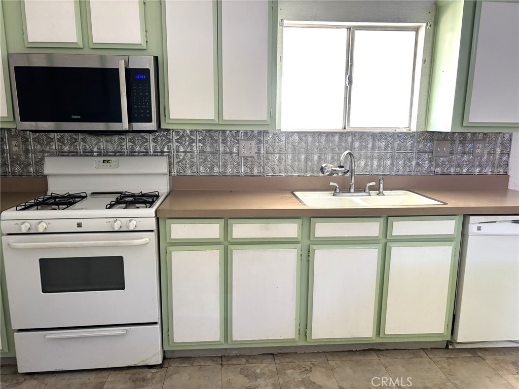 20843 Waalew Road, Unit C4 Apple Valley, CA 92307 - Photo 12 of 38 a kitchen with appliances a sink and a cabinets