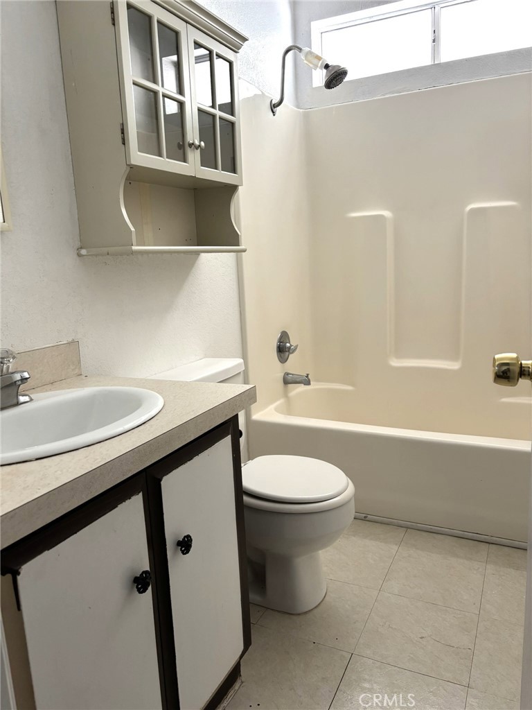 20843 Waalew Road, Unit C4 Apple Valley, CA 92307 - Photo 17 of 38 a bathroom with a sink a toilet and a bathtub