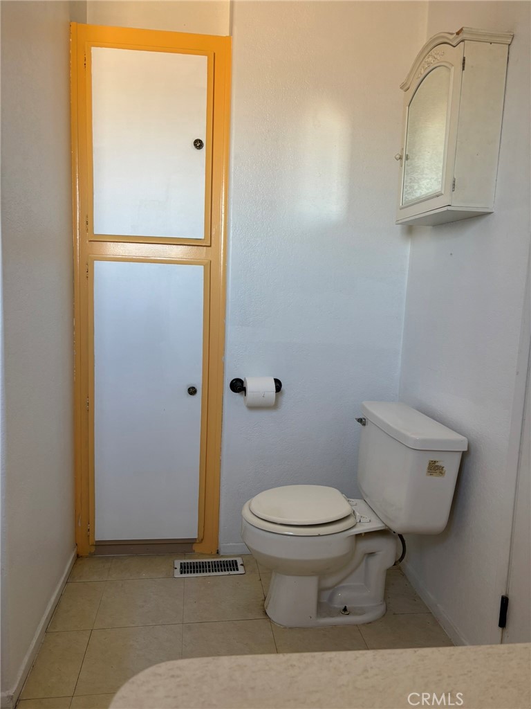 20843 Waalew Road, Unit C4 Apple Valley, CA 92307 - Photo 23 of 38 a bathroom with a toilet and a mirror