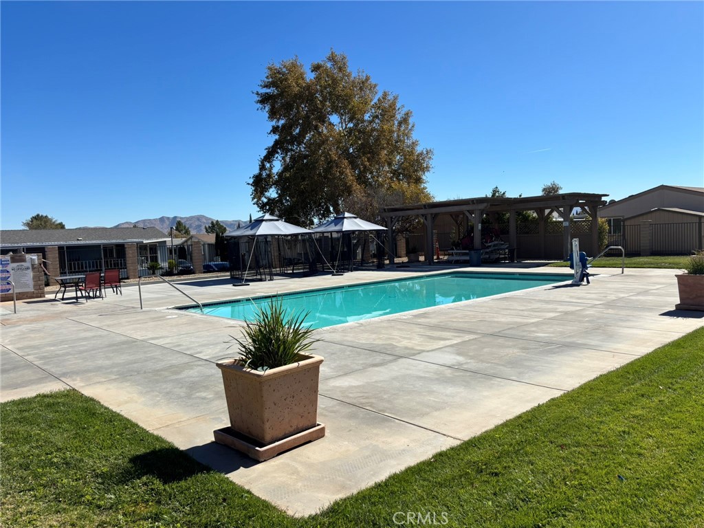 20843 Waalew Road, Unit C4 Apple Valley, CA 92307 - Photo 34 of 38 a swimming pool with outdoor seating and plants