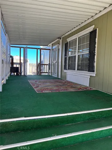a view of a backyard with plants and large trees
