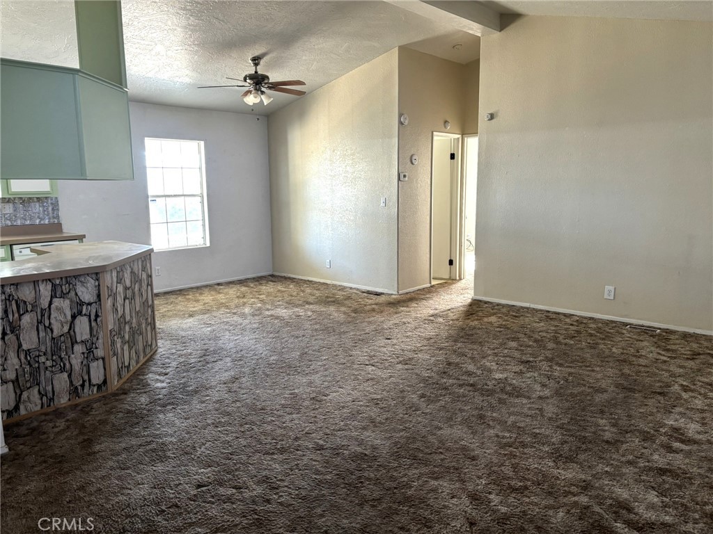 20843 Waalew Road, Unit C4 Apple Valley, CA 92307 - Photo 6 of 38 an empty room with windows and fan