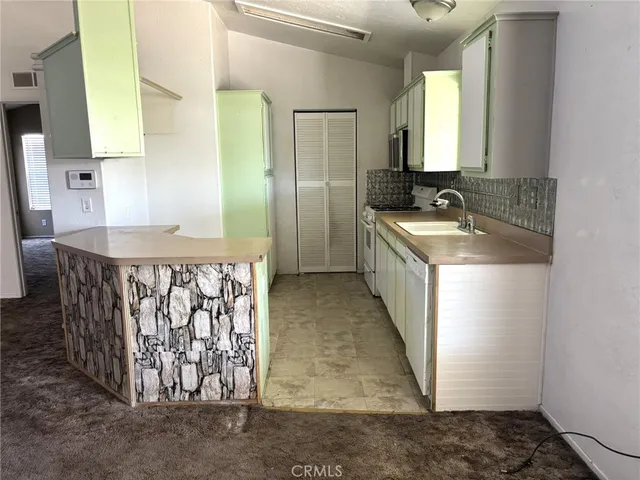 a bathroom with a granite countertop sink a toilet and a mirror