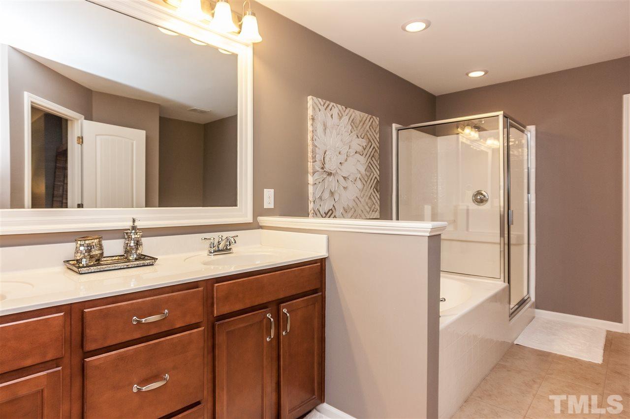 1306 Still Monument Way Raleigh, NC 27603 - Photo 12 of 25 a bathroom with a granite countertop sink mirror and double