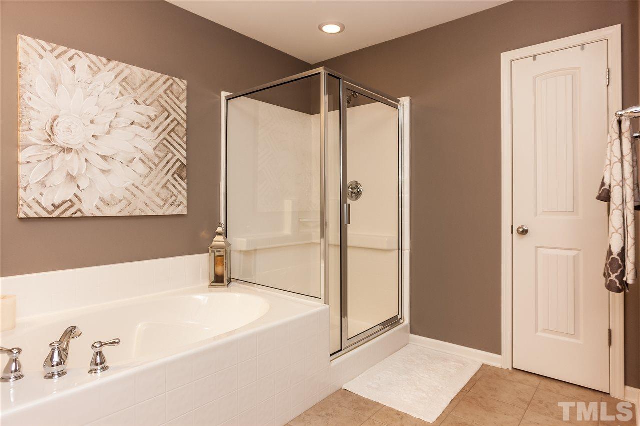 1306 Still Monument Way Raleigh, NC 27603 - Photo 13 of 25 a bathroom with a bathtub and a shower