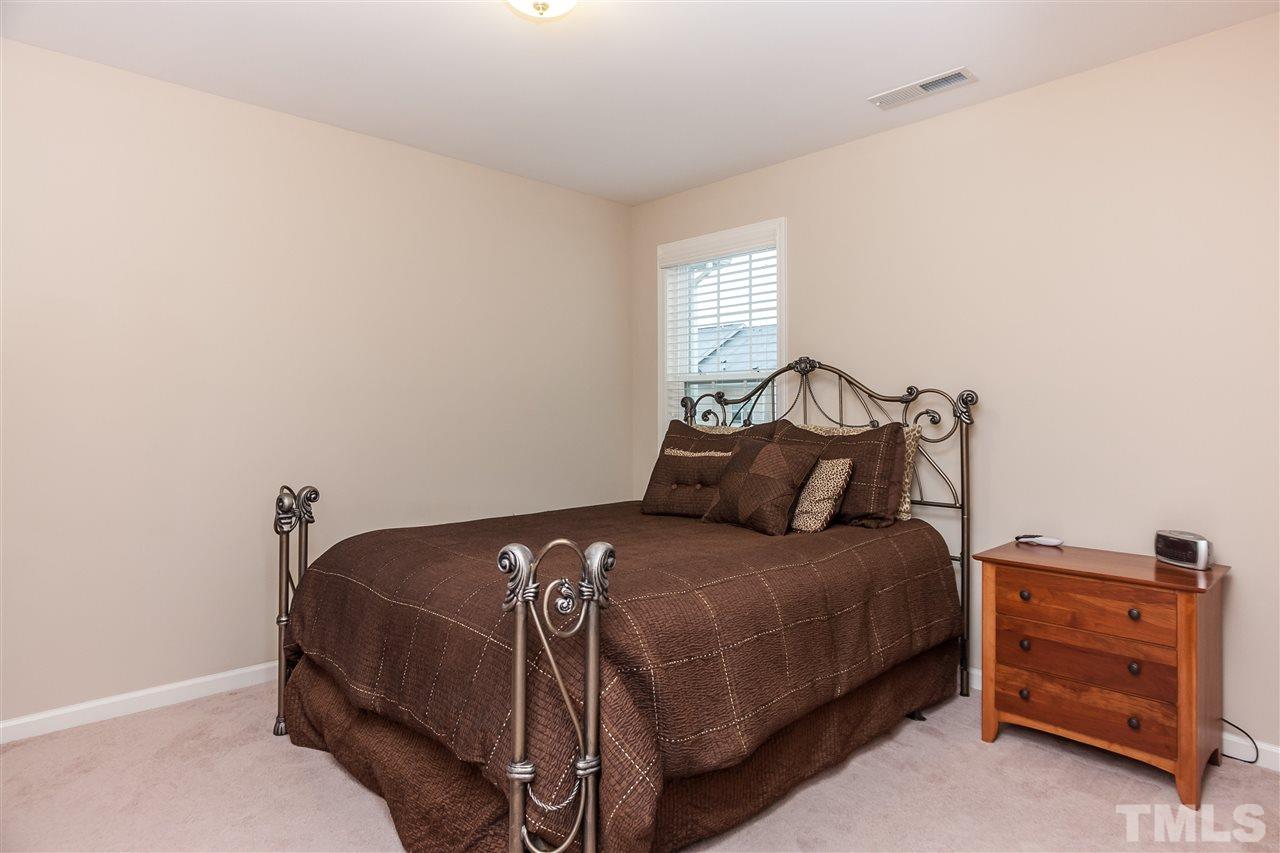 1306 Still Monument Way Raleigh, NC 27603 - Photo 14 of 25 a bedroom with a bed and a window