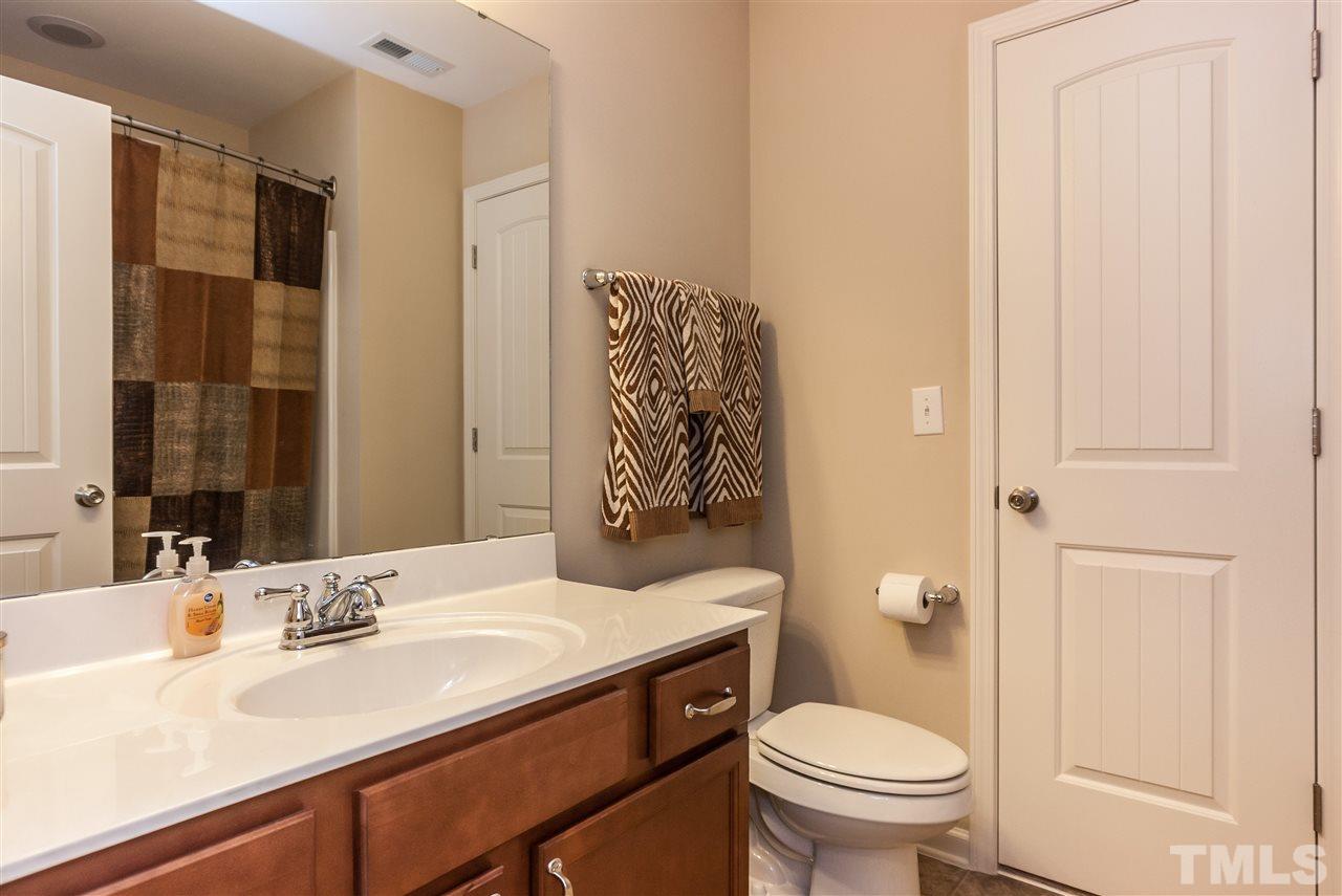 1306 Still Monument Way Raleigh, NC 27603 - Photo 15 of 25 a bathroom with a sink a toilet and shower