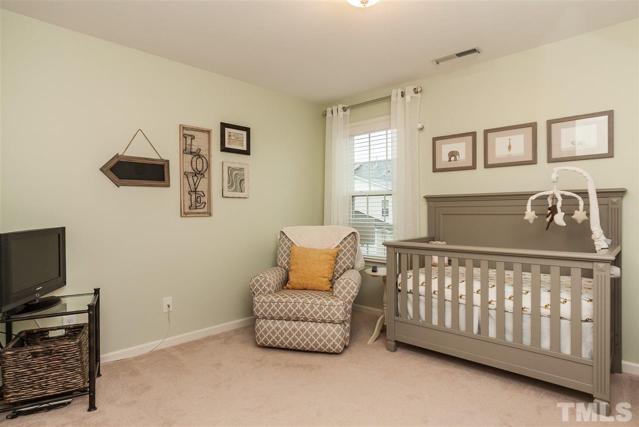1306 Still Monument Way Raleigh, NC 27603 - Photo 16 of 25 a bedroom with a bed and wooden floor