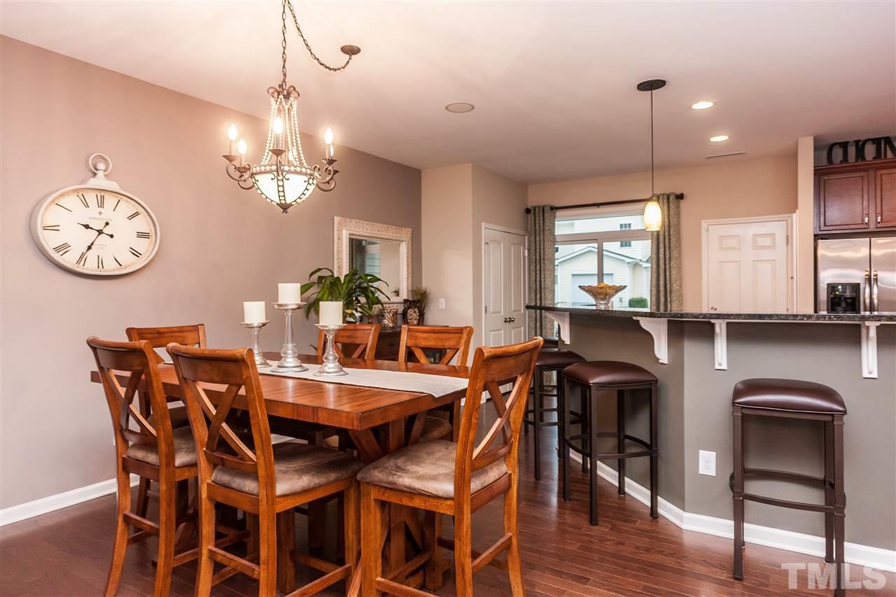 1306 Still Monument Way Raleigh, NC 27603 - Photo 25 of 25 a view of a dining room and livingroom with furniture wooden floor a chandelier