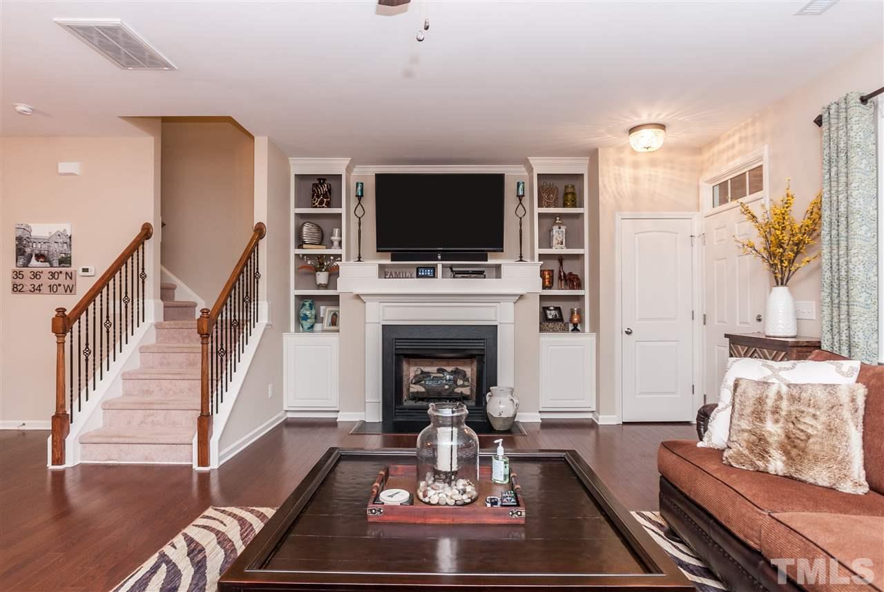1306 Still Monument Way Raleigh, NC 27603 - Photo 4 of 25 a living room with furniture fireplace and flat screen tv