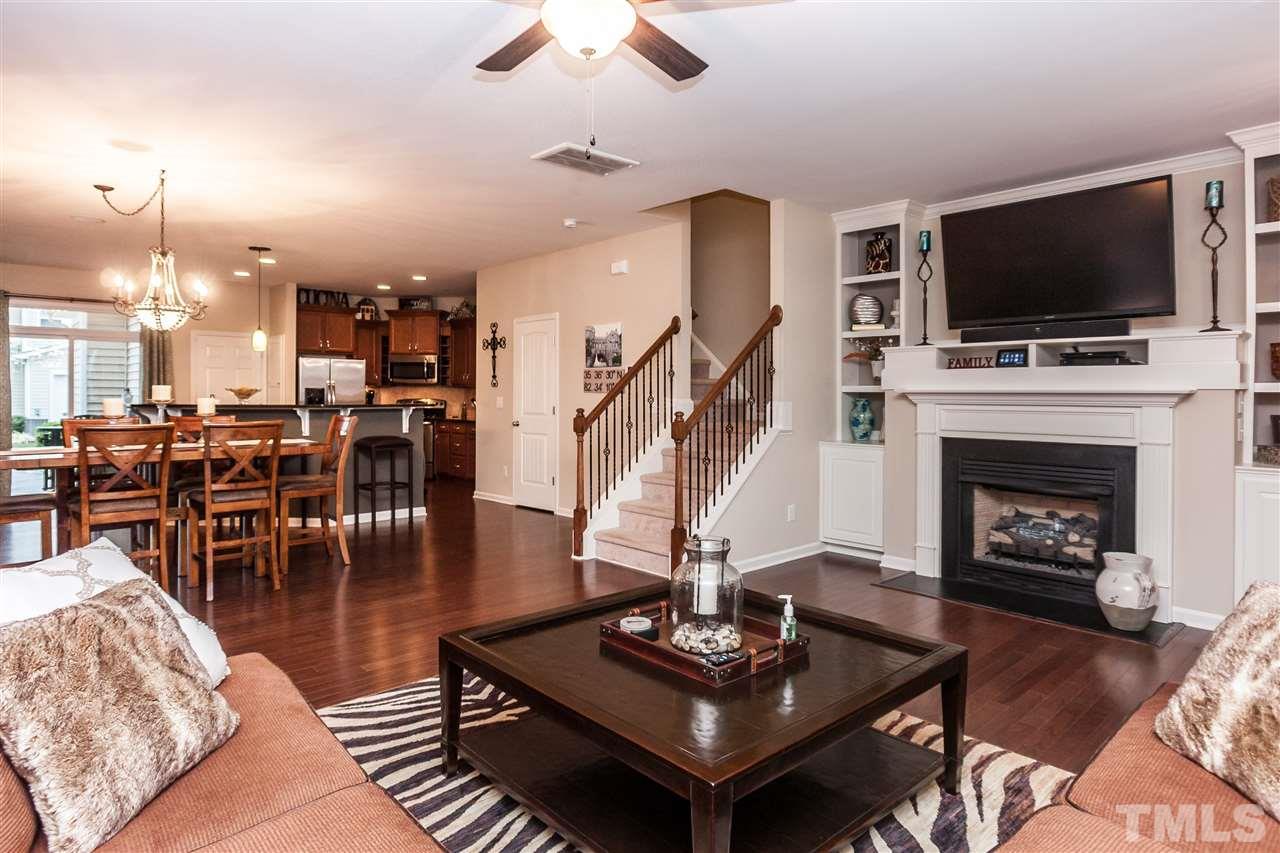 1306 Still Monument Way Raleigh, NC 27603 - Photo 5 of 25 a living room with furniture a flat screen tv and a fireplace