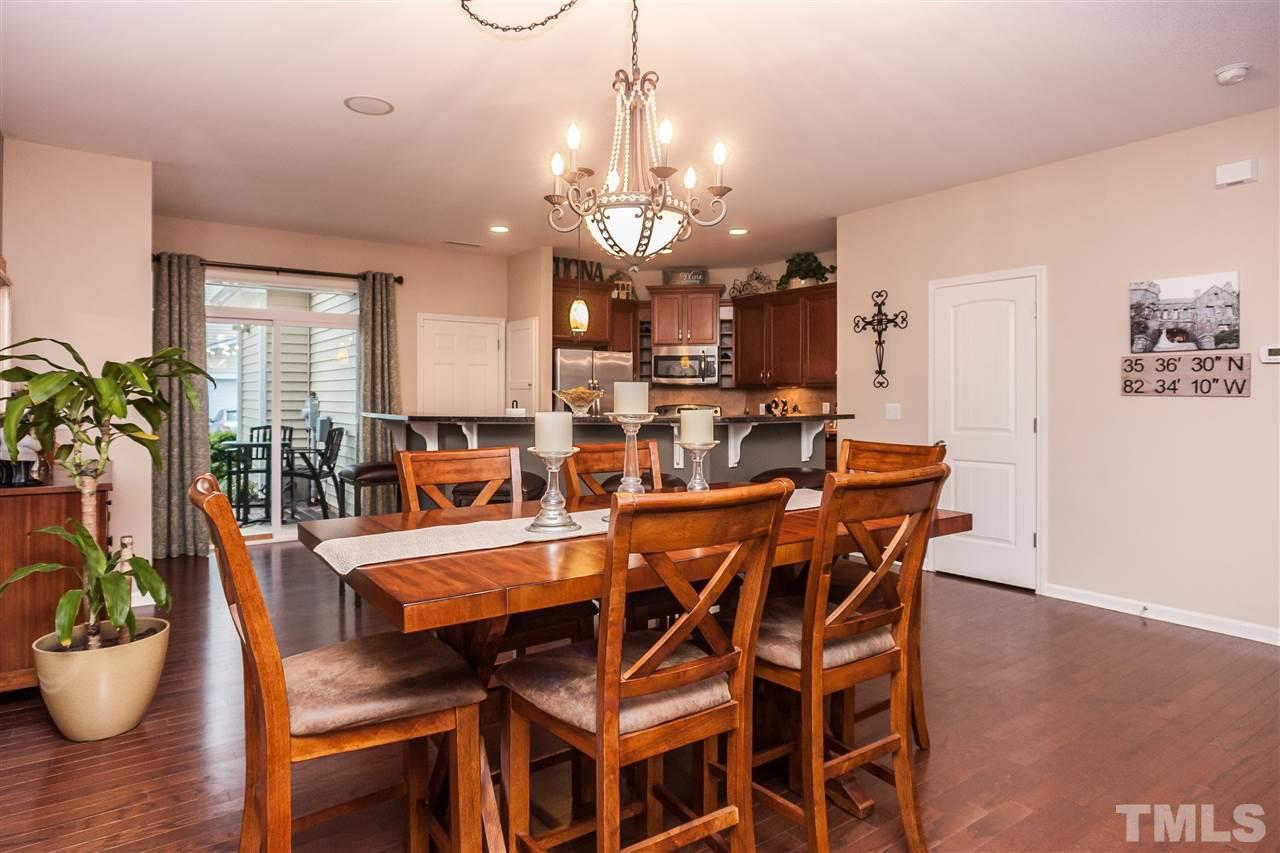 1306 Still Monument Way Raleigh, NC 27603 - Photo 6 of 25 a view of a dining room with furniture and wooden floor