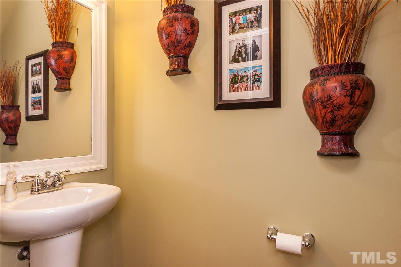 1306 Still Monument Way Raleigh, NC 27603 - Photo 9 of 25 a bathroom with a sink and a mirror