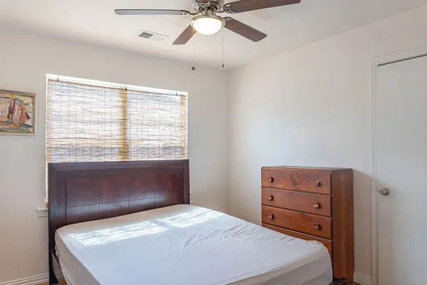 a bedroom with a bed and a window