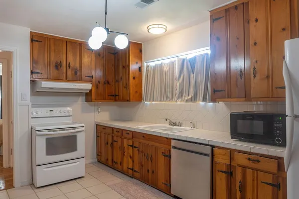 a kitchen with a sink cabinets and window