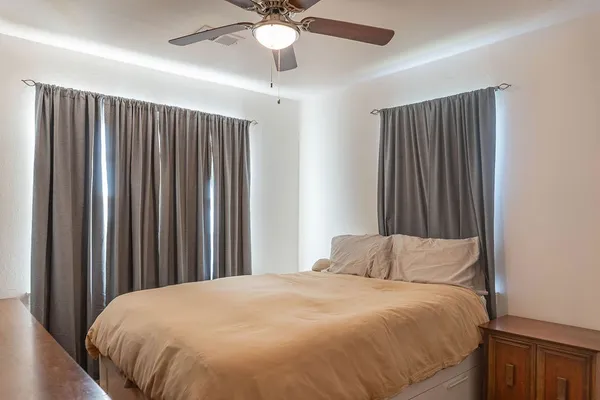 a bedroom with a bed and a chandelier