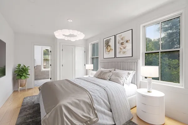a bedroom with a bed and a large window