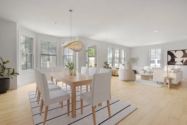 a view of a dining room with furniture window and wooden floor