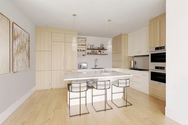 a kitchen with a table chairs refrigerator and cabinets