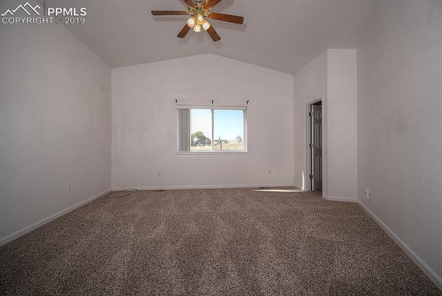 11625 Rex Road Peyton, CO 80831 - Photo 25 of 36 Master bedroom with a walk in closet adjacent