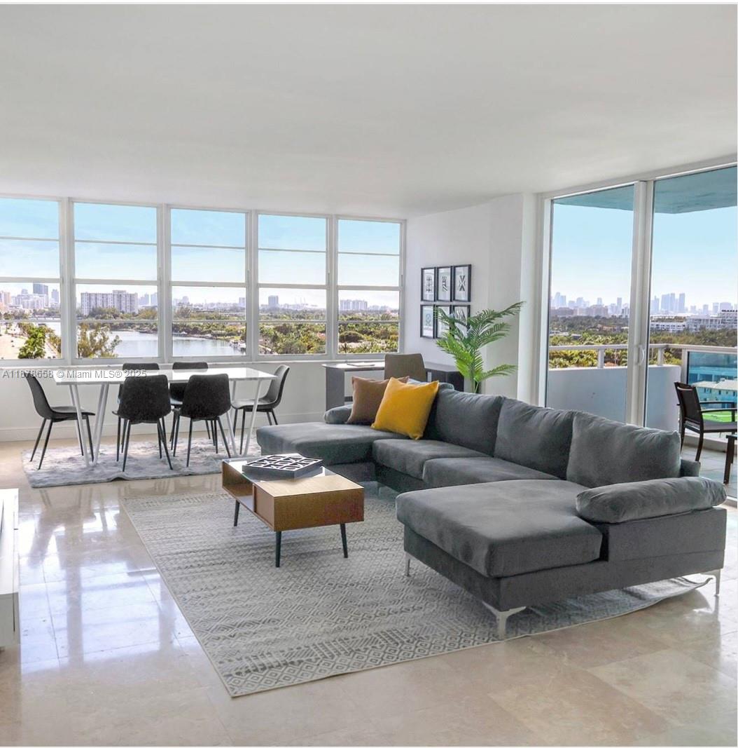 5101 Collins Avenue, Unit 14A Miami Beach, FL 33140 - Photo 12 of 14 a living room with furniture and a large window