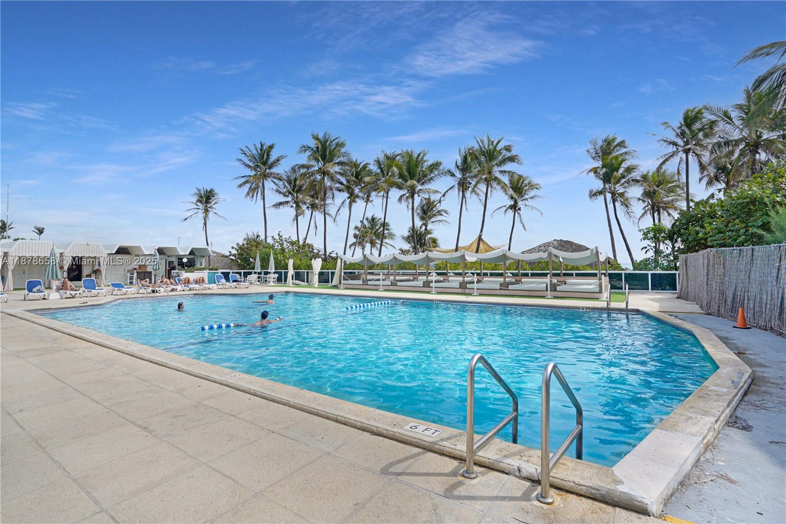 5101 Collins Avenue, Unit 14A Miami Beach, FL 33140 - Photo 14 of 14 a view of swimming pool with a table and chairs