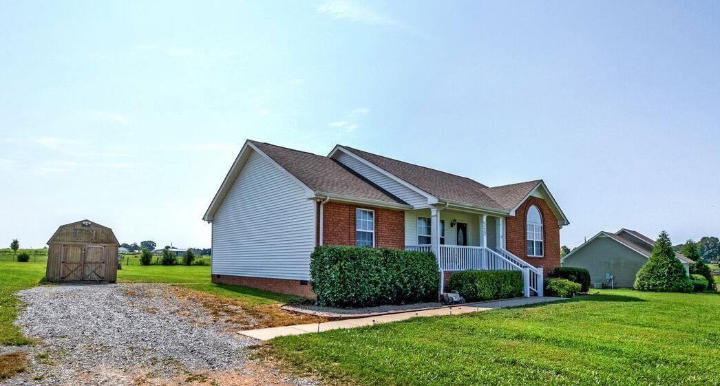 722 Lear Road Portland, TN 37148 - Photo 1 of 20 a front view of a house with garden