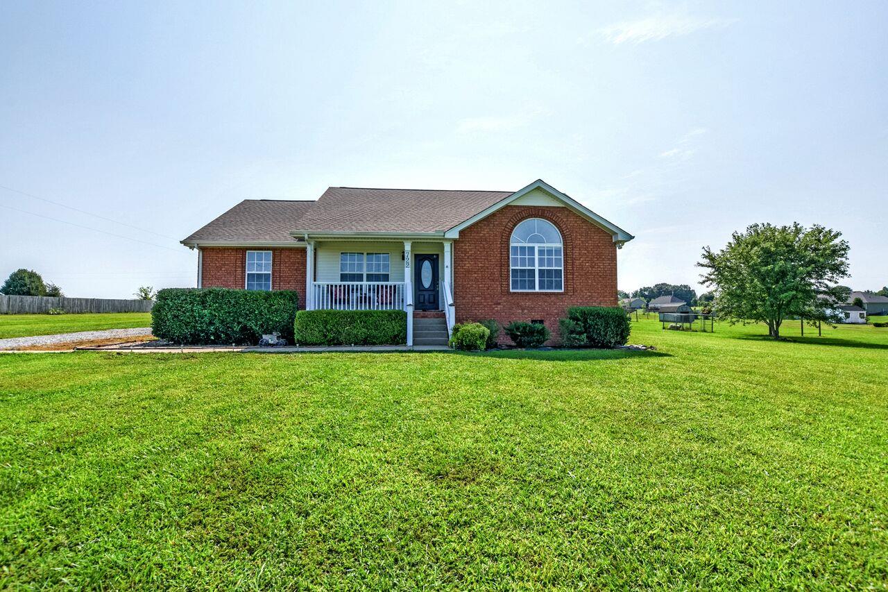722 Lear Road Portland, TN 37148 - Photo 2 of 20 a front view of a house with a yard and garage