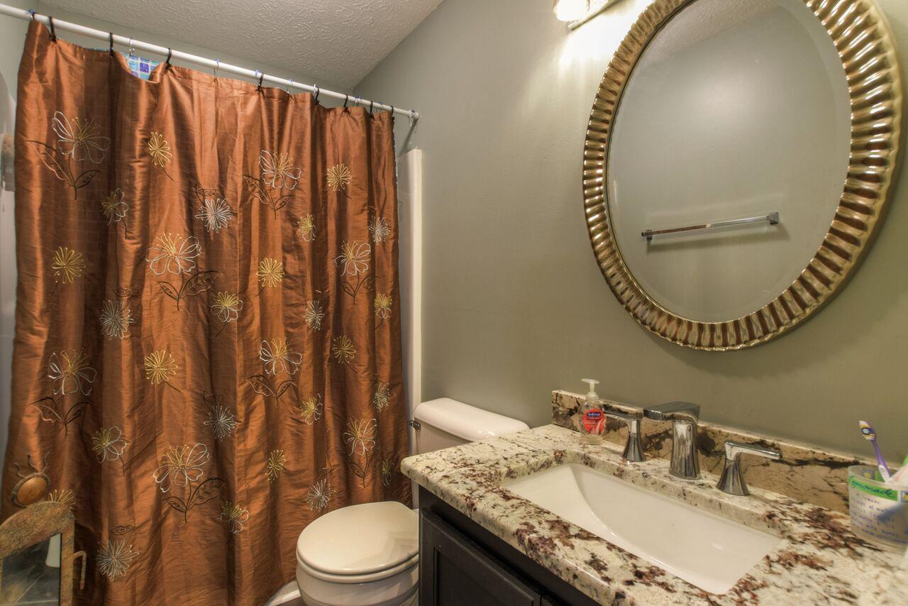 722 Lear Road Portland, TN 37148 - Photo 17 of 20 a bathroom with a granite countertop sink vanity mirror and toilet