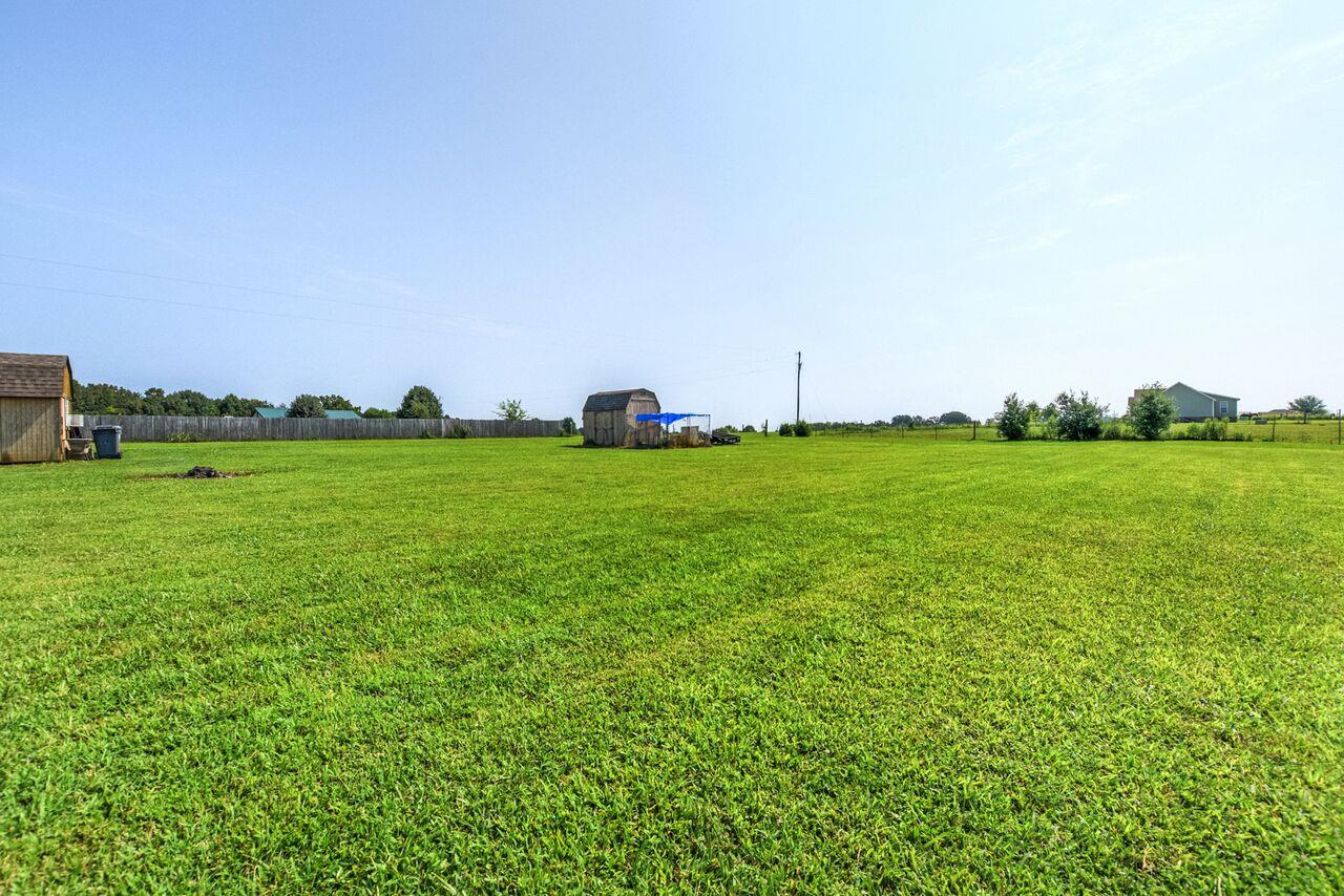 722 Lear Road Portland, TN 37148 - Photo 19 of 20 a view of a grassy field with an trees