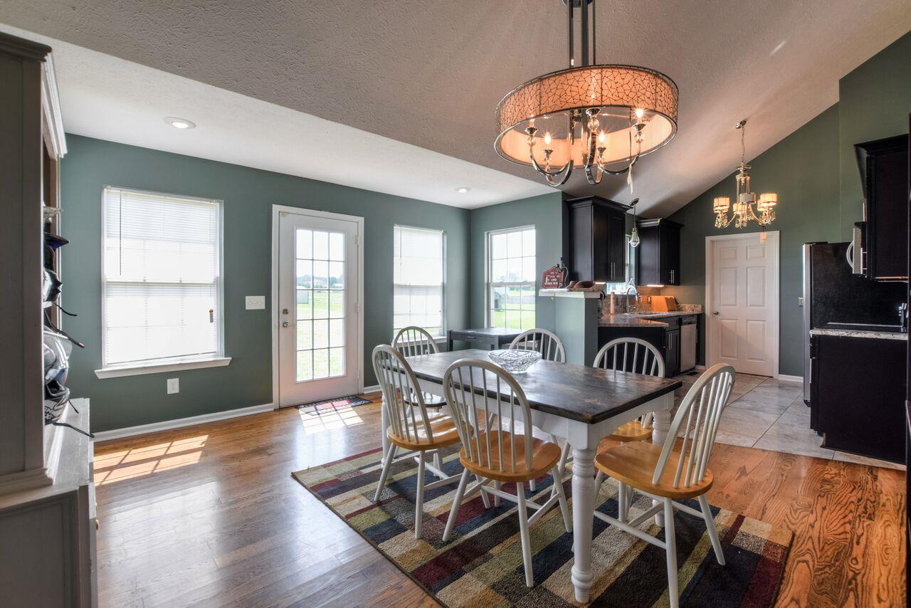 722 Lear Road Portland, TN 37148 - Photo 6 of 20 a view of a dining room with furniture a chandelier and wooden floor