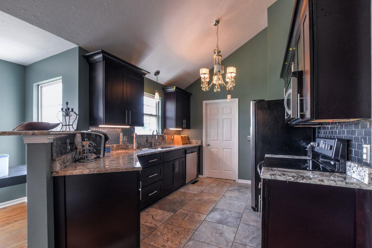 722 Lear Road Portland, TN 37148 - Photo 8 of 20 a large bathroom with a sink a large mirror and a refrigerator